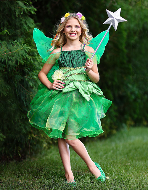 Tinker Bell costume with green dress and fairy wings displayed against a forest backdrop